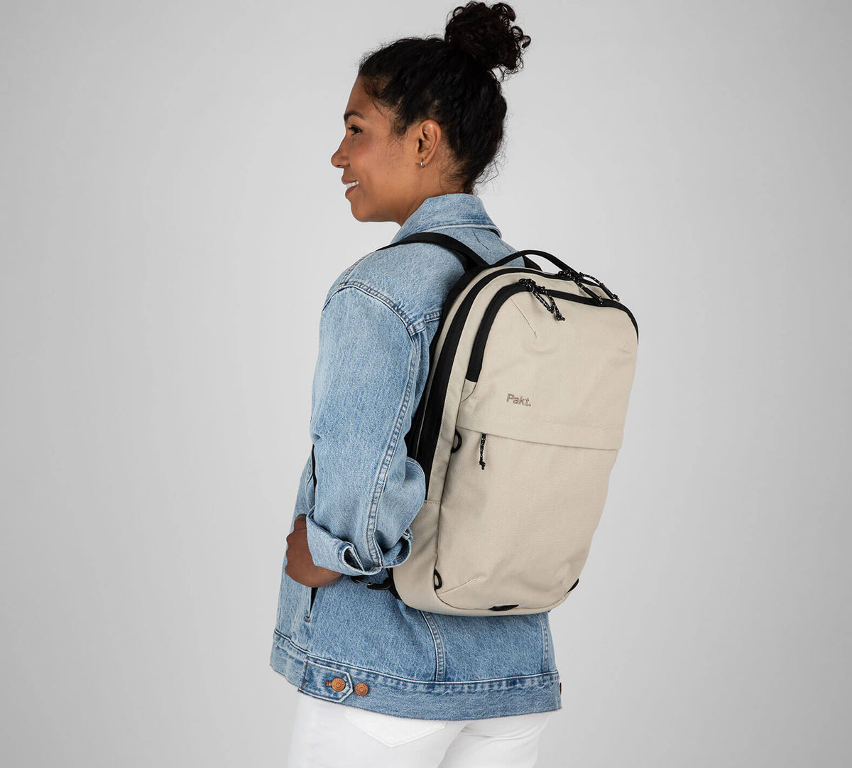 Woman with tan sling backpack
